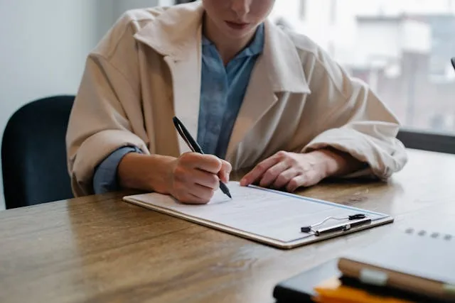 A person filling out a rental document